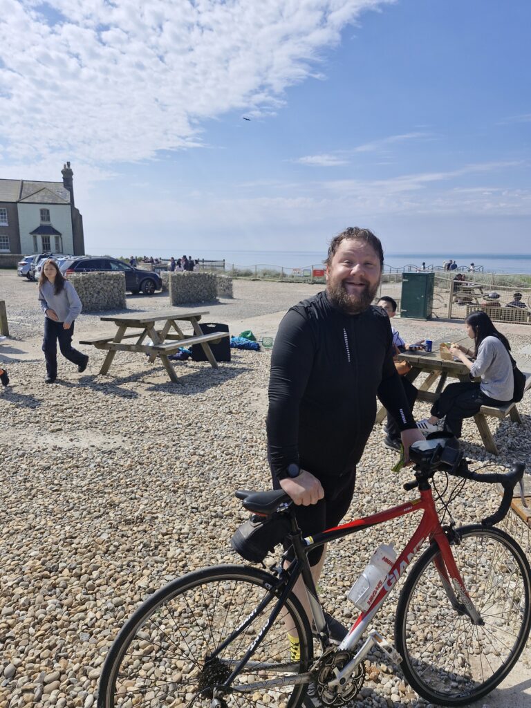 The current image has no alternative text. The file name is: COM.Robert-Cooke-and-bike-scaled.jpg